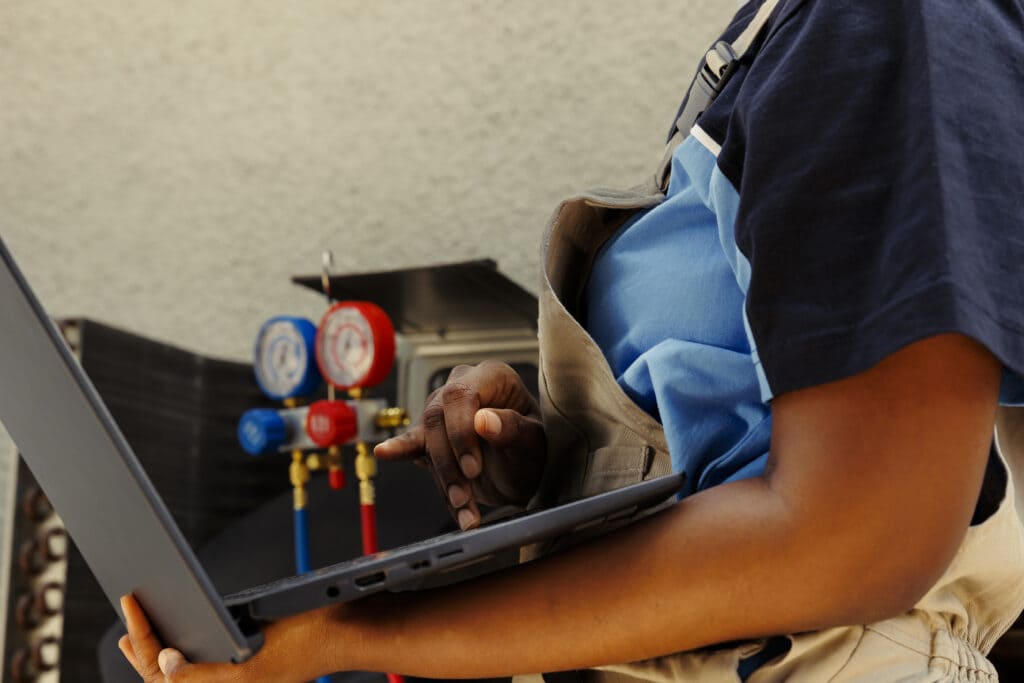 A woman holding the laptop in her hands and working on it
